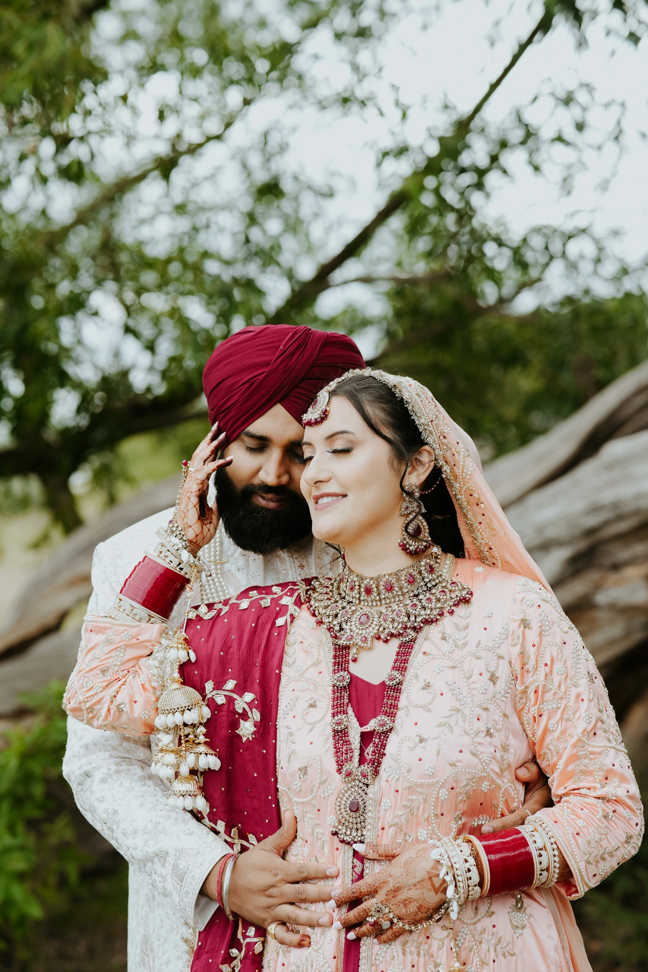 Bride and groom in traditional attire sharing an embrace